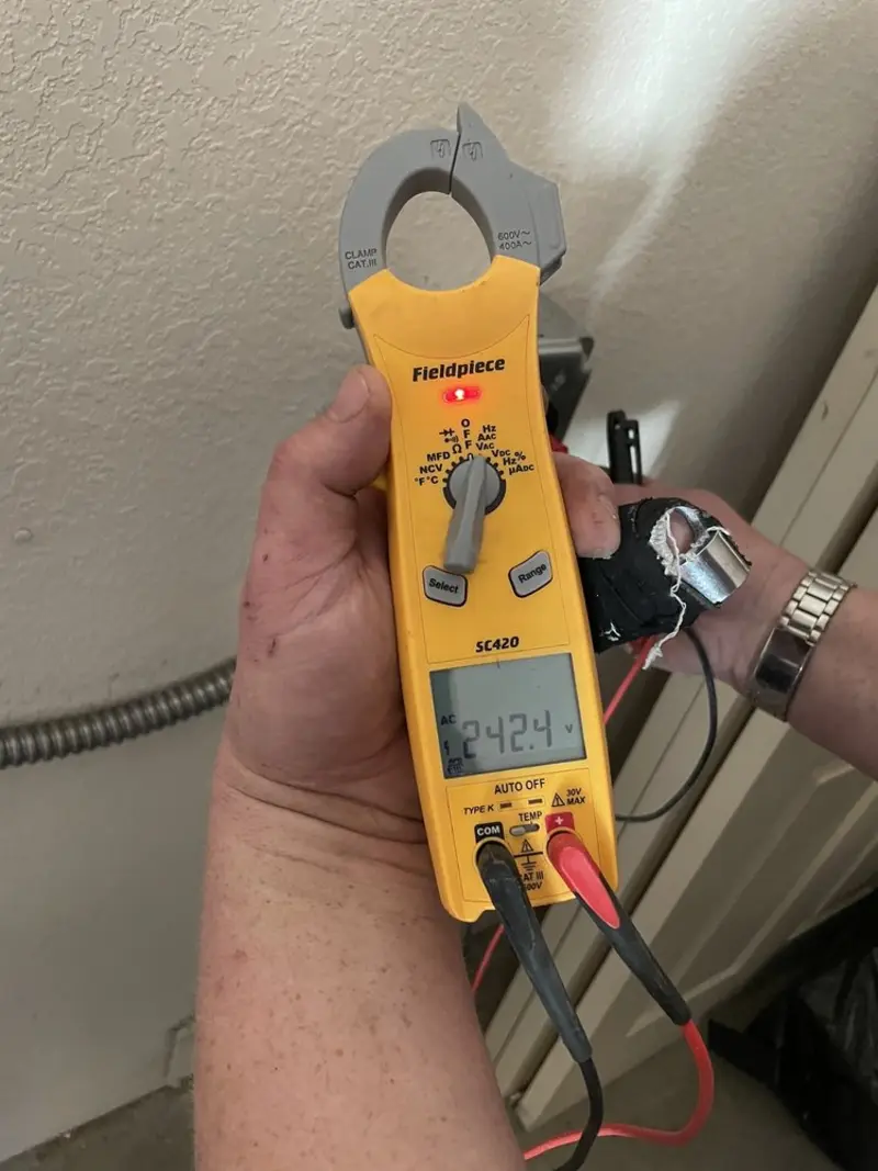 Voltage testing with clamp meter during Electrical Installation Services in Cannon AFB